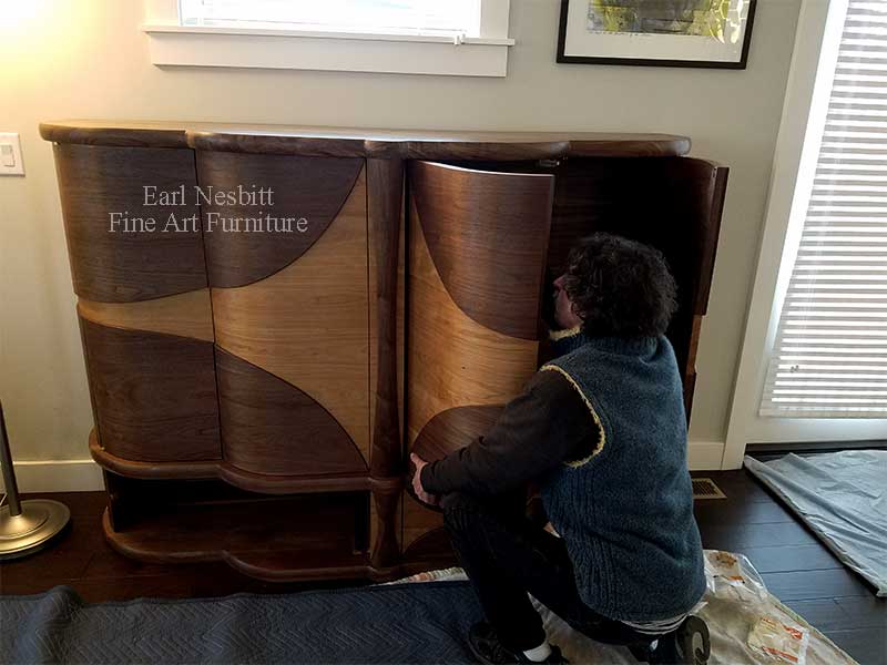 Earl installing retractable door for a custom made art deco liquor cabinet Earl installing retractable door for a custom made art deco liquor cabinet